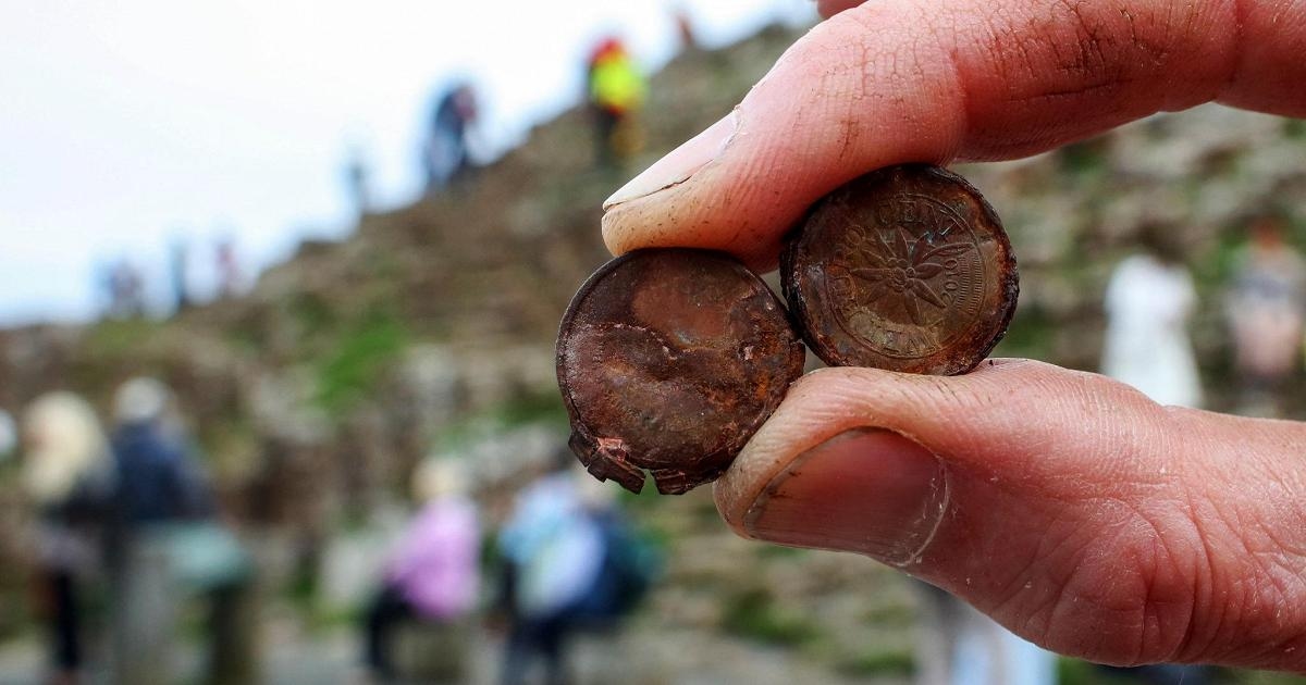 Tourist coins undermine the Giant Causeway in Northern Ireland